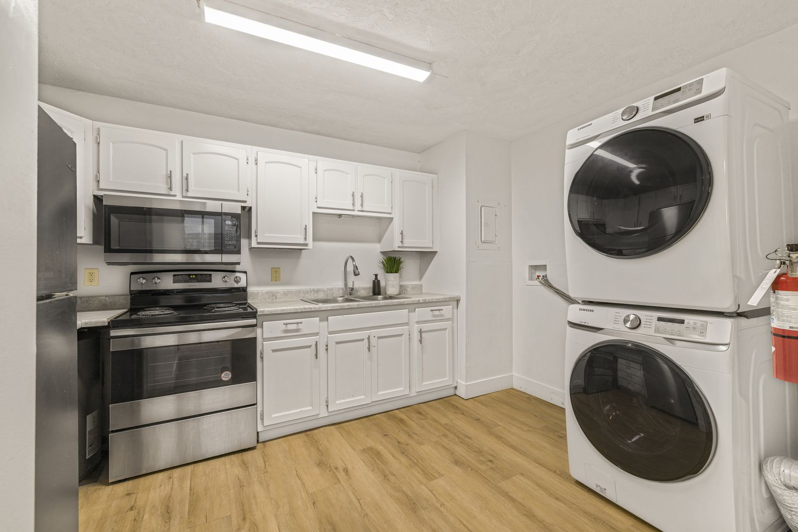 Kitchen with stacked laundry